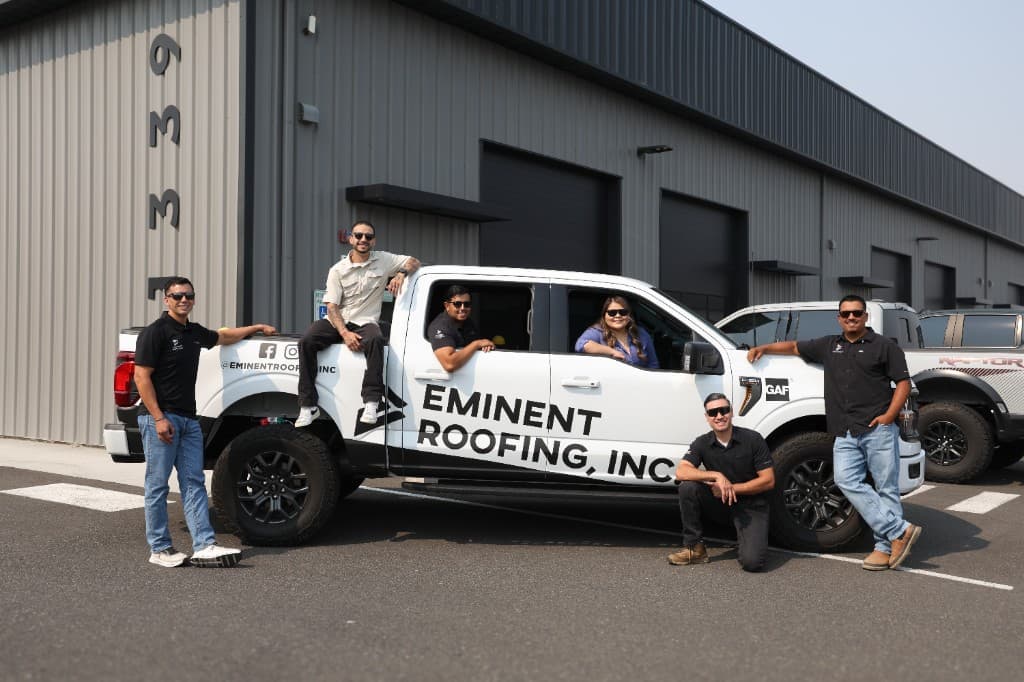 Eminent Roofing team with a branded company truck at the Richland shop
