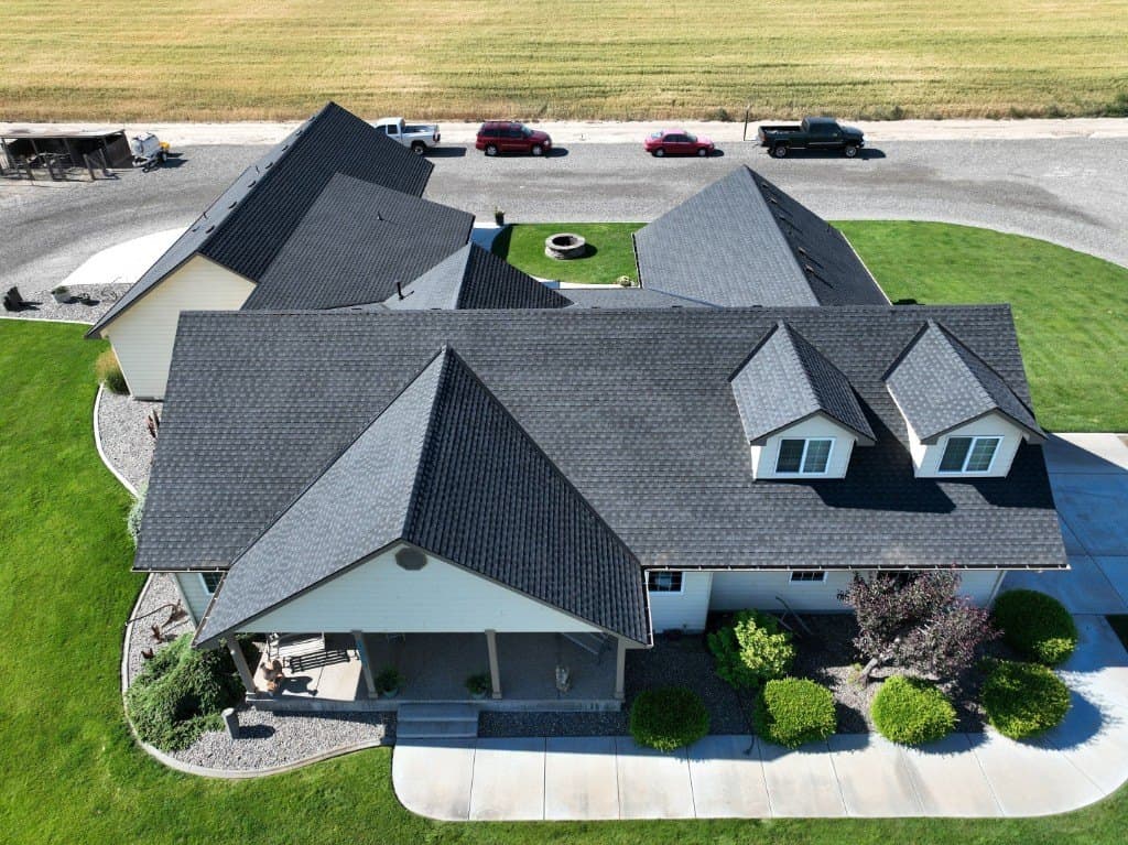 Aerial view of a completed dark-shingle roof on a Tri-Cities home