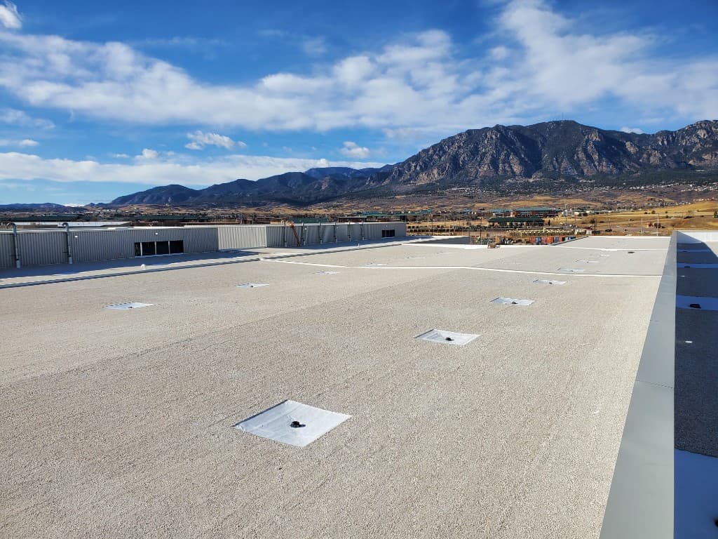 Low-slope commercial roof with parapet coping