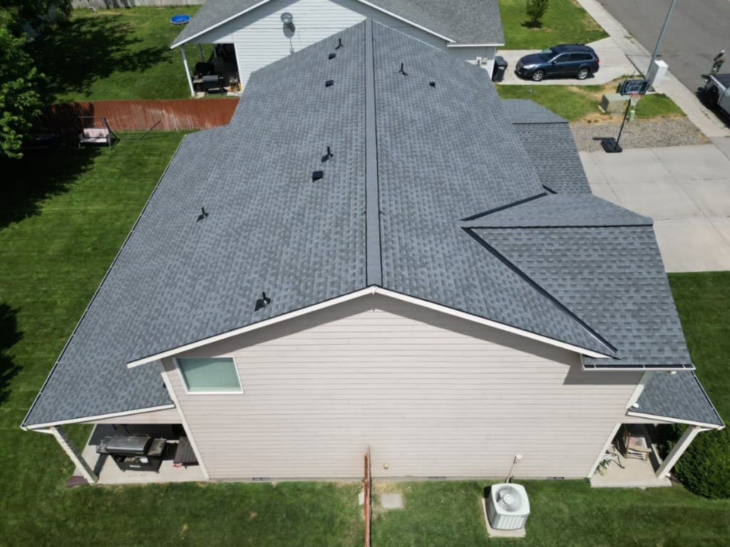 Side aerial of a completed Pewter Gray shingle roof and patio in West Richland