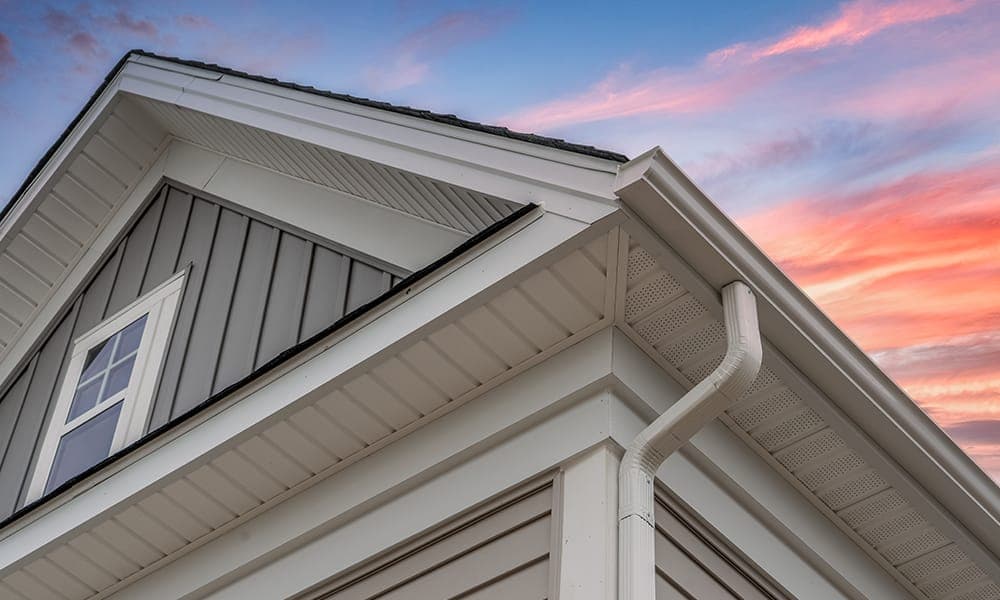 White gutters and downspout on a Tri-Cities home with dark shingles and modern siding