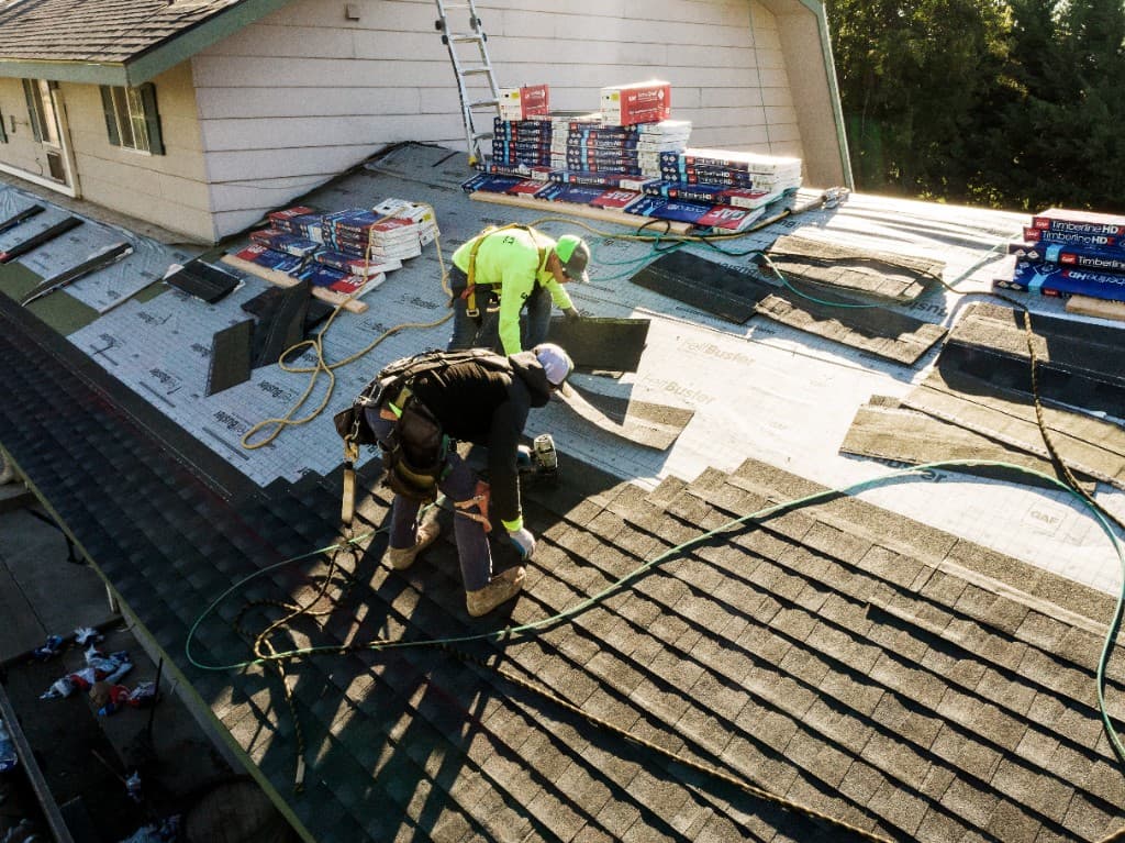 Eminent Roofing crew installing GAF Timberline shingles over FeltBuster underlayment