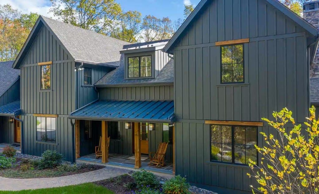 Farmhouse-style home with board-and-batten siding and a steep roof, the kind of rural-residential exterior we work near Finley