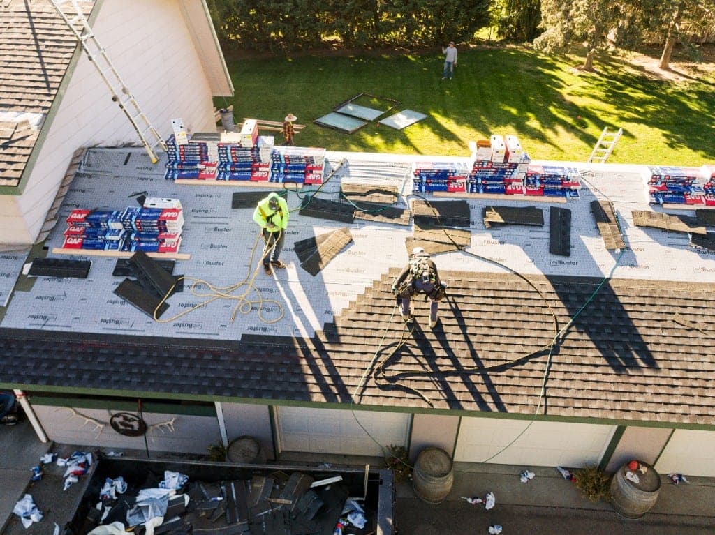 Aerial view of a completed residential roof with architectural shingles